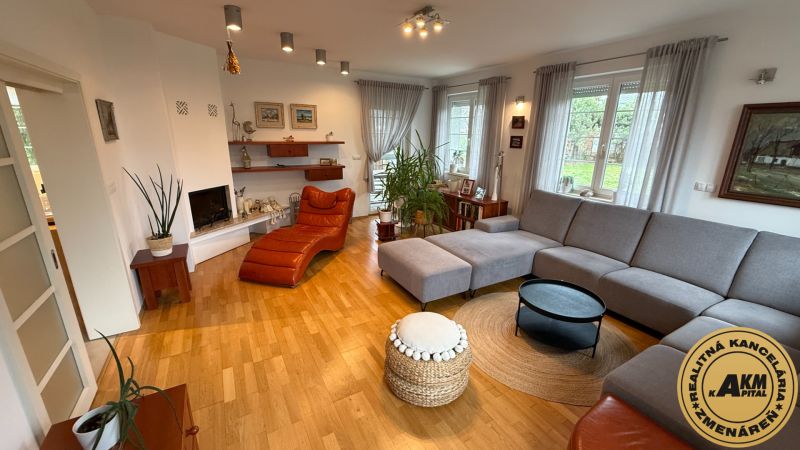 Living room in a family house with a comfortable corner sofa and a floor with a wood decor.