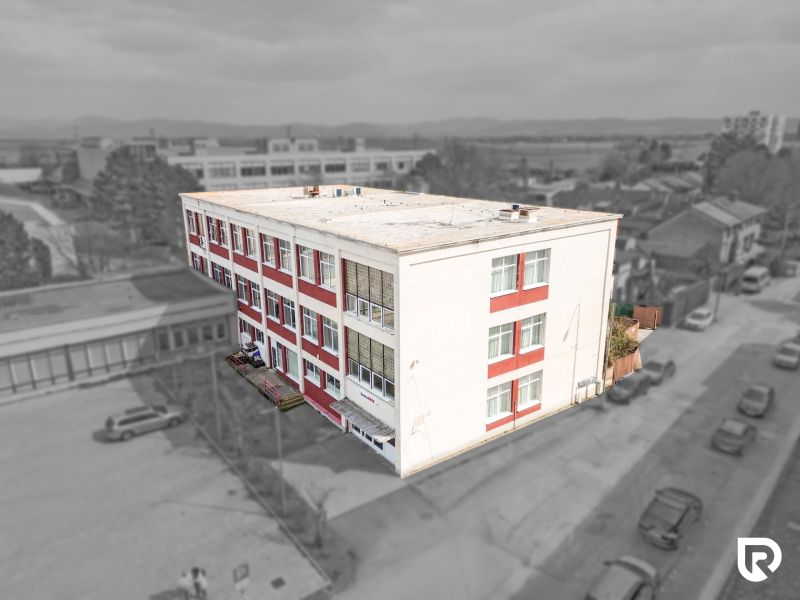 The building with red stripes on Jána Zigmundíka Street in the town of Vrbové, commercial premises.