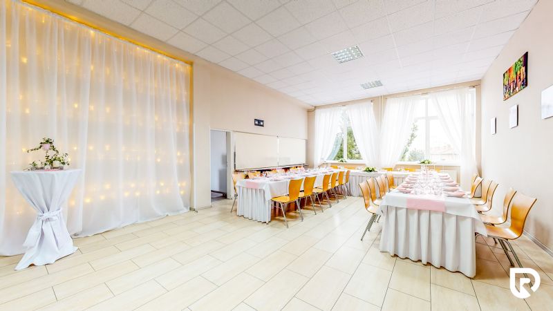 Commercial spaces with wood-patterned flooring, decorations, and tables with place settings.