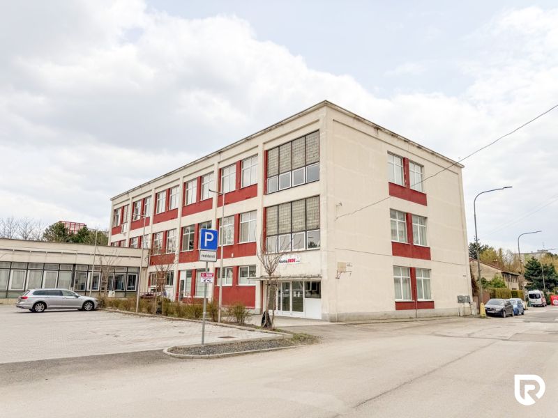 Building on Jána Zigmundíka Street in Vrbové, part commercial spaces with parking.