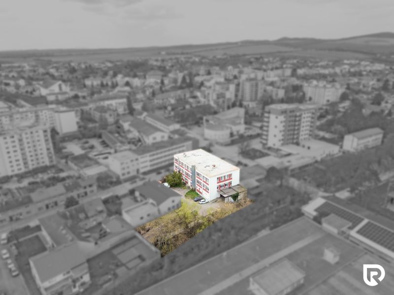 A building of commercial premises on Jána Zigmundíka Street in Vrbové surrounded by greenery.