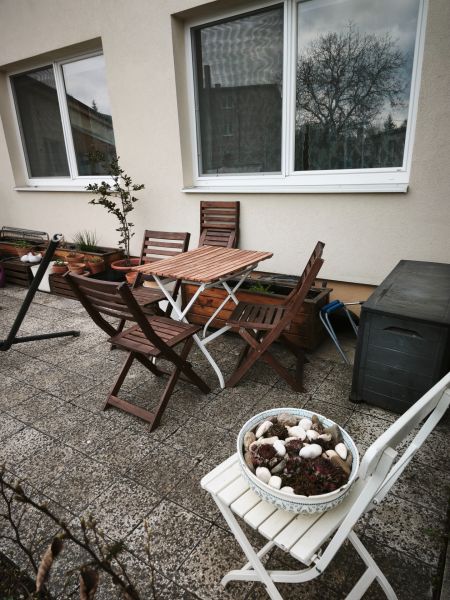 A terrace with wooden furniture at a 4-room apartment in Malá Lehota.