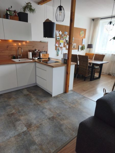 A kitchen in a 4-room apartment with wood decor and a comfortable dining nook.
