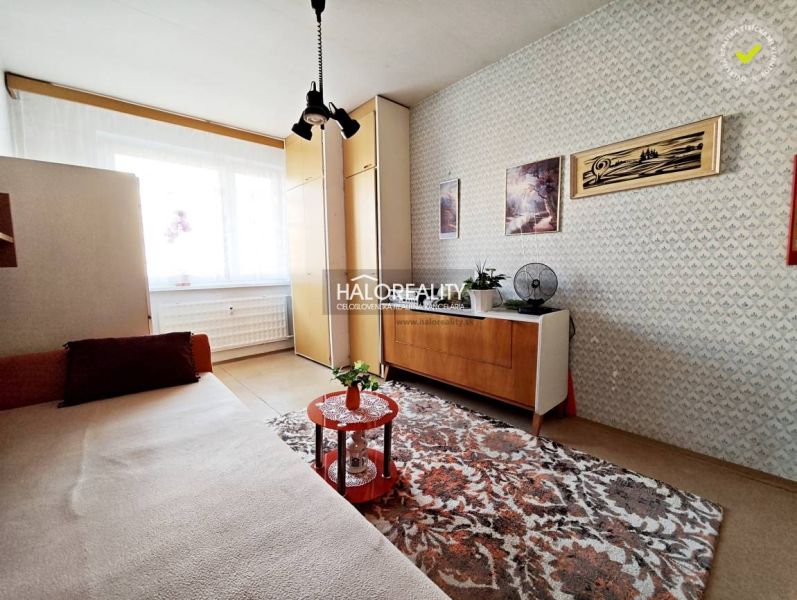 Living room in a 2-room apartment with retro furniture and a carpet.