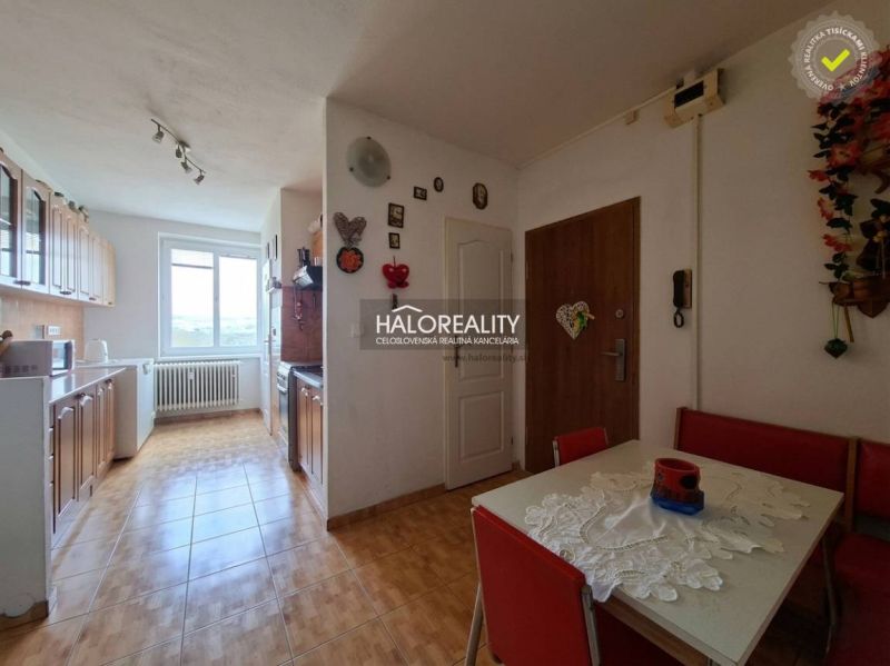 A kitchen in a 3-room apartment with tiles and a dining table.