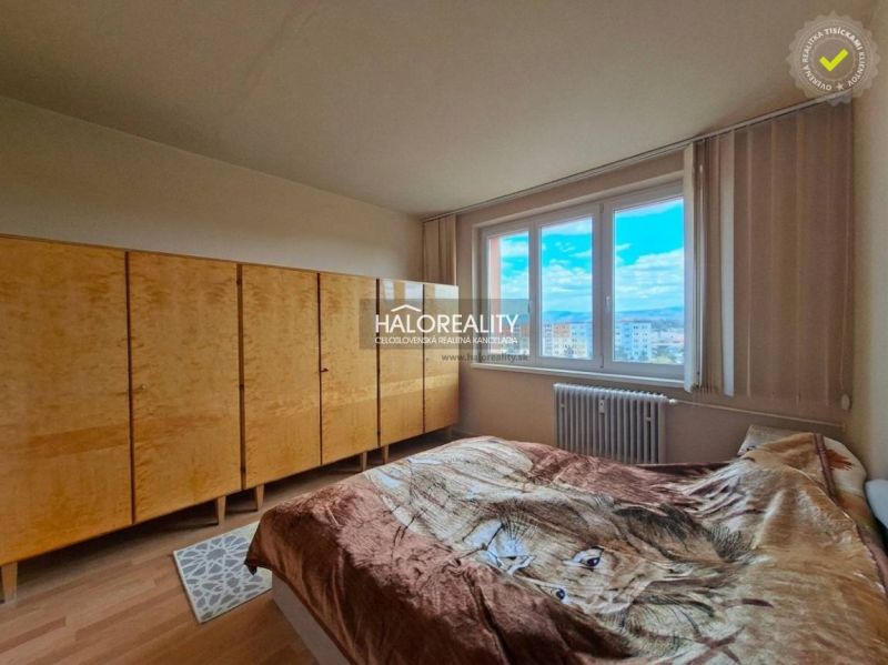 Bedroom with a bed and large wardrobes in a 3-room apartment.