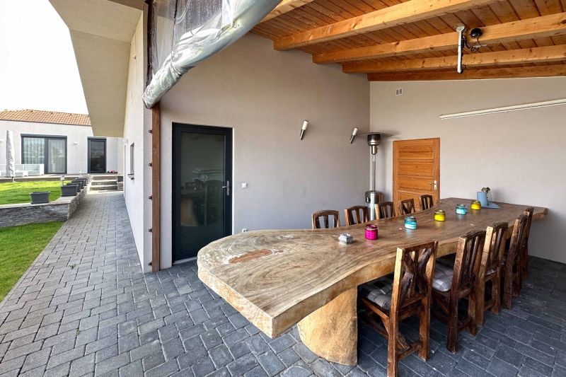 Family house in Pama with a terrace, a massive table, and outdoor seating.