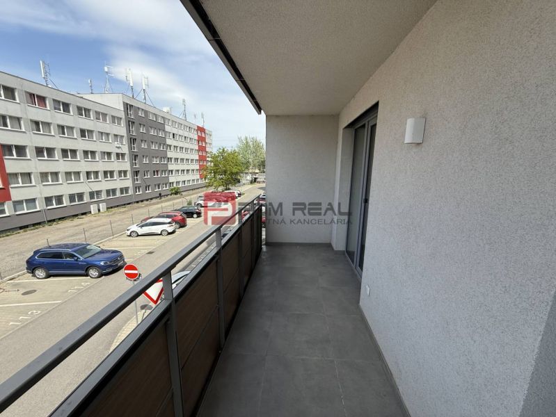 A balcony with a view of the parking lot and buildings on Galvaniho Street, Bratislava II.