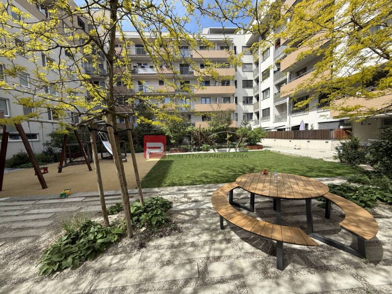 Playground and bench in the garden of the apartment complex on Galvaniho Street in Bratislava II.