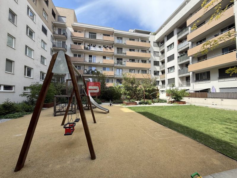 Courtyard with a children's playground surrounded by apartment buildings on Galvaniho in Bratislava II.