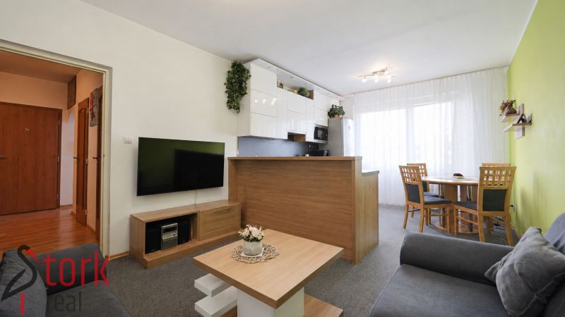 Living room in a 3-room apartment with a kitchenette and a dining table.