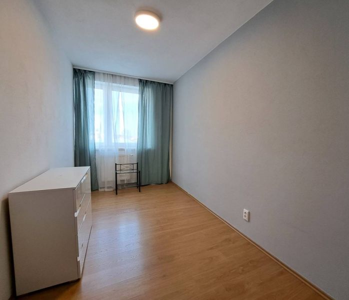 A room in a 3-room apartment with a wooden decor floor and natural light.
