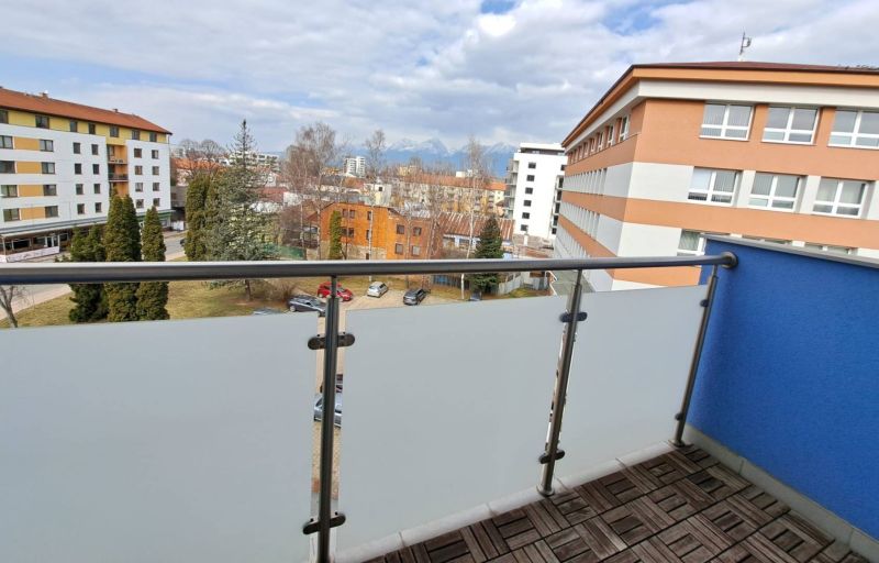 View from the balcony of a 3-room apartment in Poprad with a wooden decor floor.