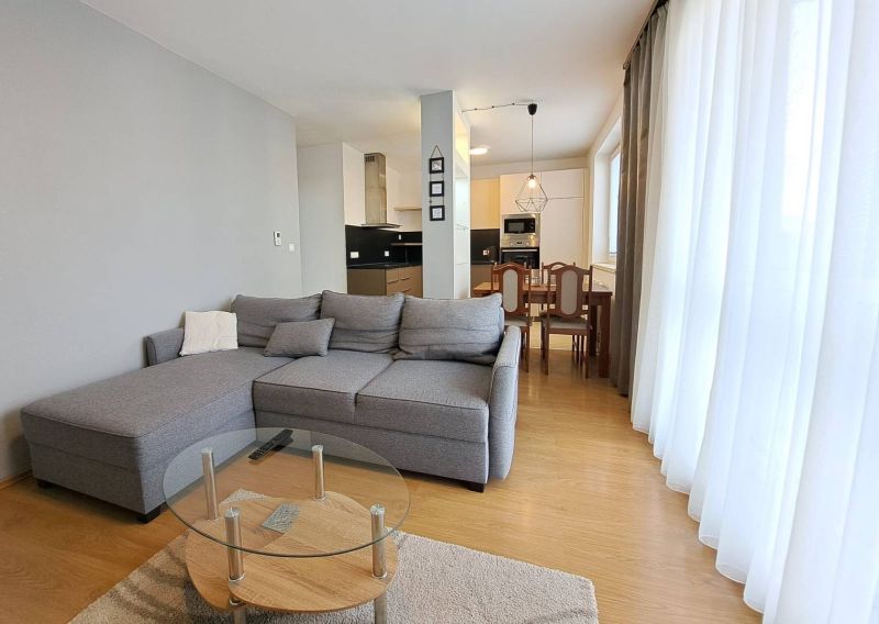 Living room in a 3-room apartment with a corner sofa and a kitchenette.