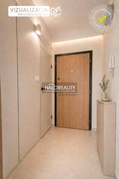 A studio apartment with a light interior, entrance door, and decorative element on the wall.