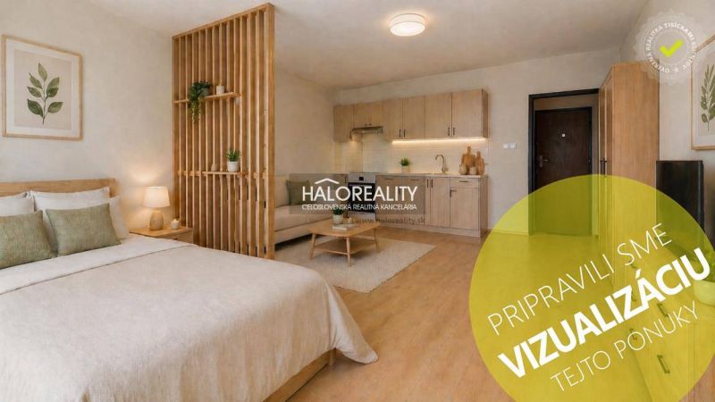 Studio apartment with a bed, kitchenette, and wood-patterned flooring.