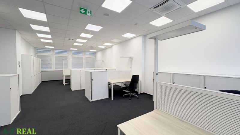 Offices with arranged desks and storage cabinets without decor.