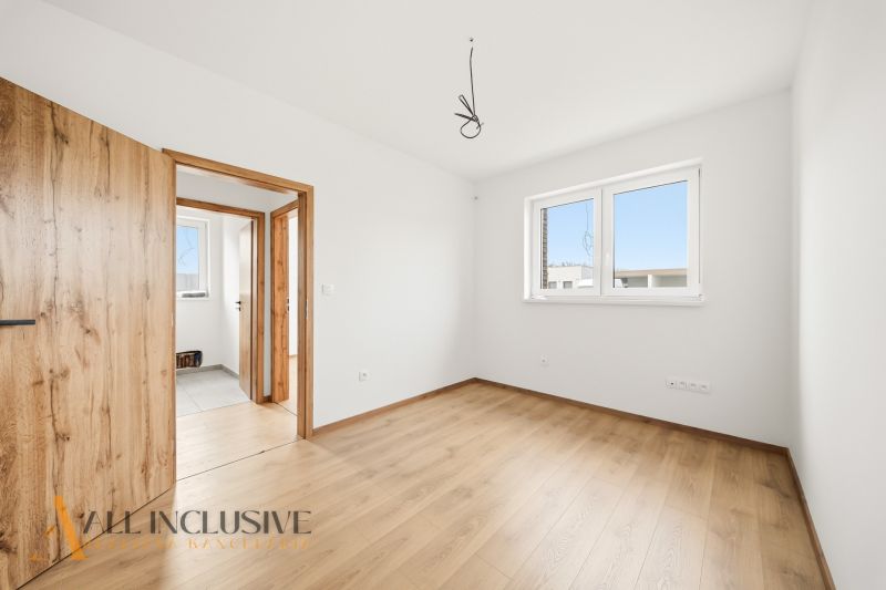 Interior of a family house with a wooden decor floor and white walls.