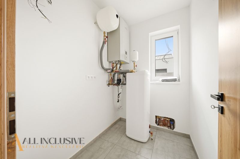 The interior of a family house with technical equipment and tiles on the floor.