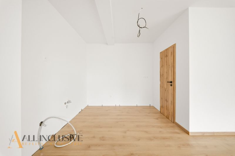 Interior of a family house with white walls and a wooden decor floor.