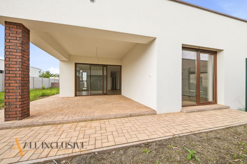 A family house in Dunajský Klátov with a light facade and glass doors to the terrace.