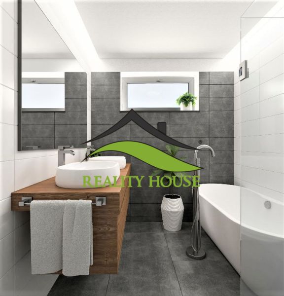 A bathroom in a family house with a bathtub, a sink on a wooden countertop, and a window.