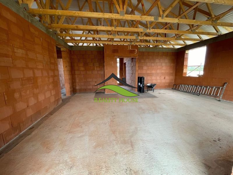 Construction of a family house with brick walls and a wooden ceiling in Michalovce on Hlavná Street.