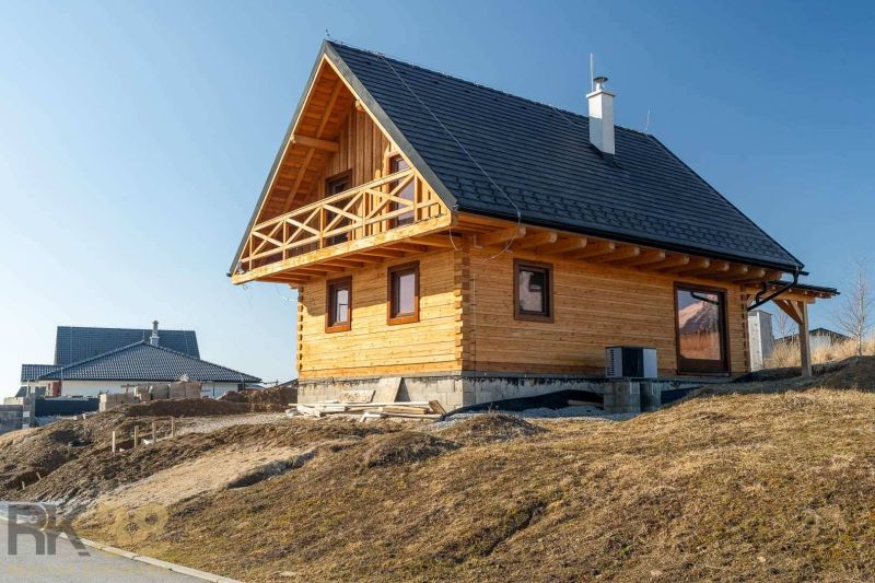 A family house in Stará Lesná with a wooden facade and a sloped roof.