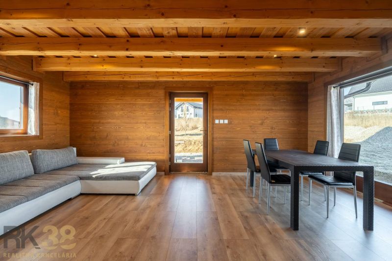 Living room in a family house with a wooden decor floor and a comfortable sofa set.