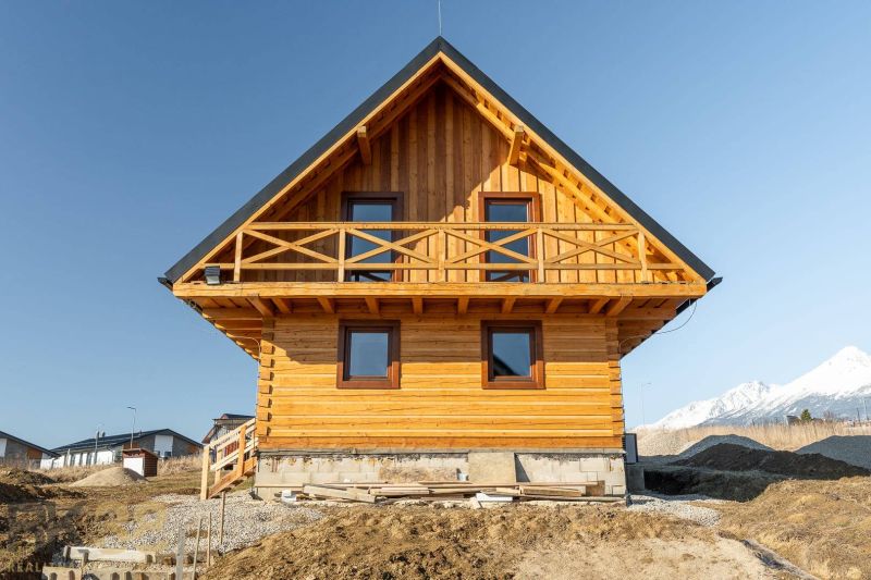 A family house in Stará Lesná with a wooden facade and a mountain backdrop.