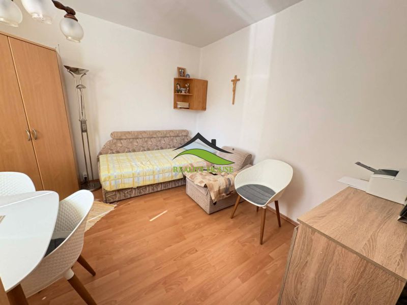 Living room in a 4-room apartment with a wooden decor floor and a wardrobe.