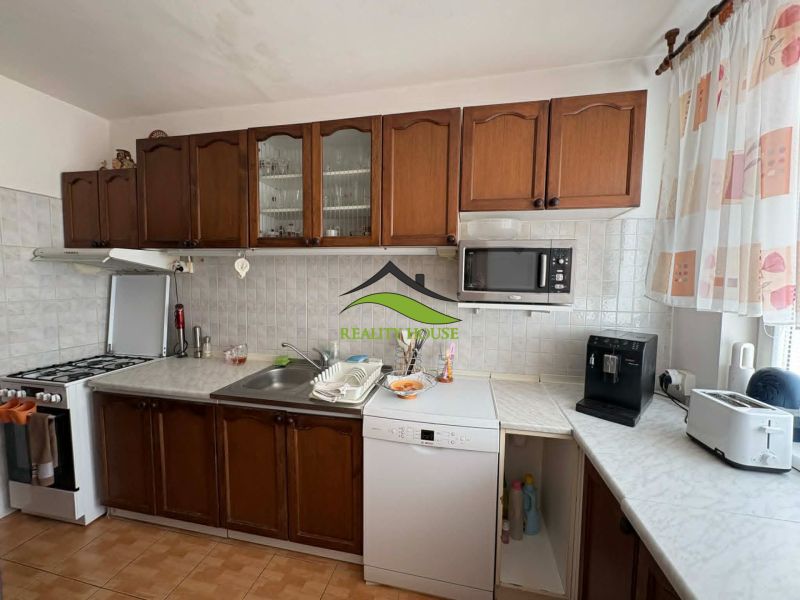 Kitchen in a 4-room apartment with dark cabinets and kitchen appliances.