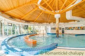 Indoor pool with a wooden ceiling in the area for plots - housing.