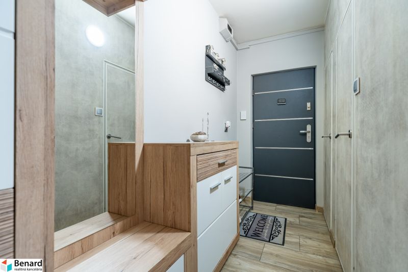 The interior of the hallway with a wooden decor floor in a 2-room apartment.