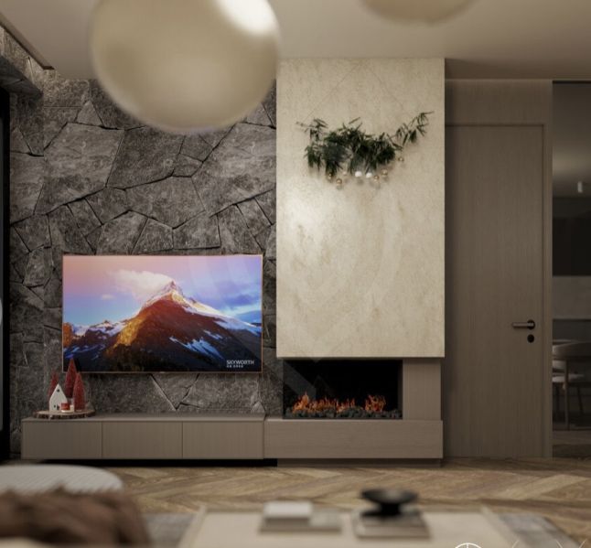 Interior of a holiday apartment with a television, fireplace, and wood-patterned flooring.