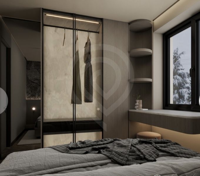 A bedroom in a holiday apartment with storage space next to the window.