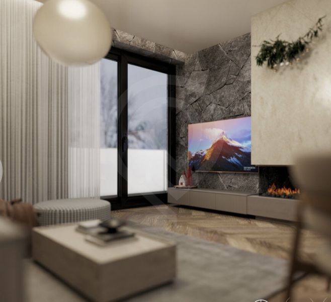 Recreational apartment with a fireplace, wooden decor flooring, and a television on a stone wall.