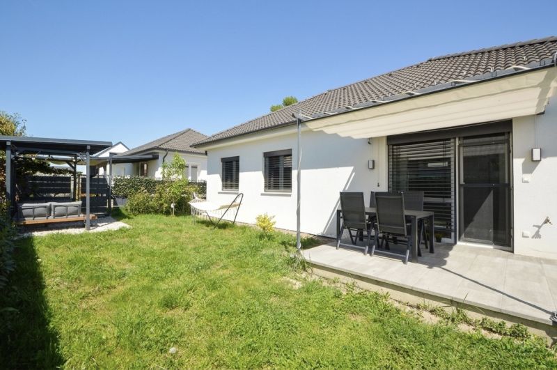 A family house in Rajka with a terrace, garden seating, and a green lawn.