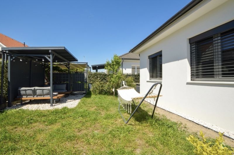 A family house in Rajka with a terrace, lawn, and a hammock in the garden.