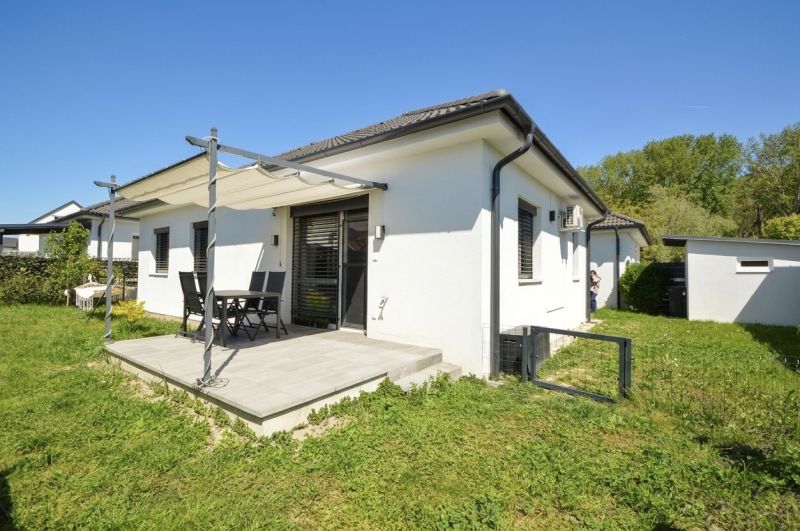 A family house in Rajka with a terrace and a shelter in the middle of a green garden.
