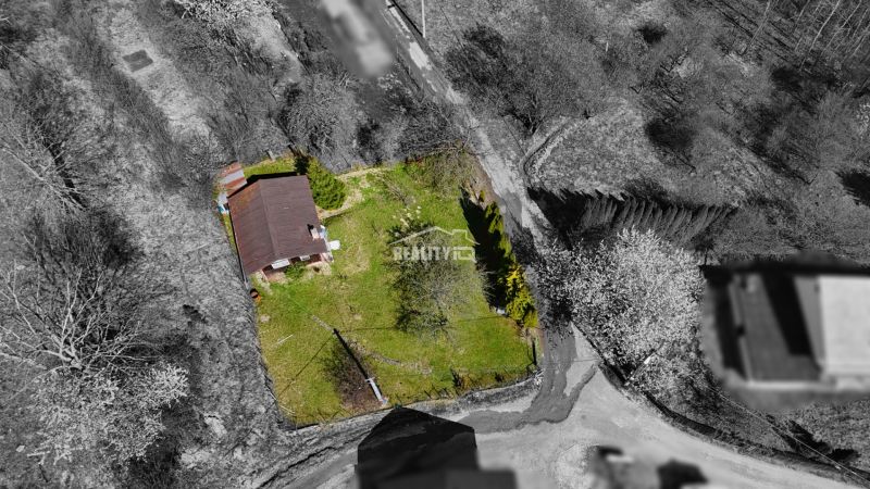 A cottage in Krásno nad Kysucou with a large lawn and surroundings from a bird's eye view.