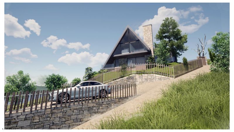 A cottage in Podhradí with a stone fence on a slope among trees and a blue sky.