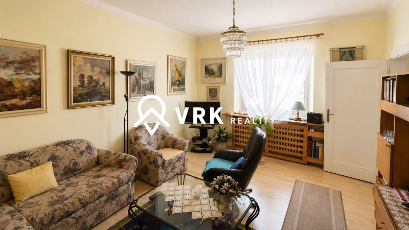 Living room in a family house with floral patterns and a wooden decor floor.