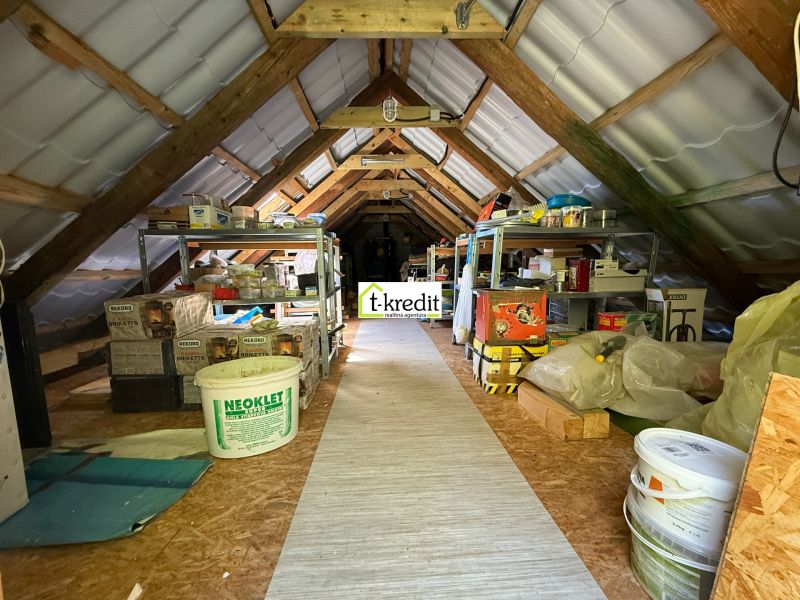 The attic of the family house used as a storage space with a wooden floor decor.