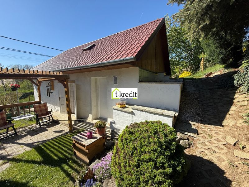 A family house in Čaradice with a terrace, garden seating, and picturesque surroundings.