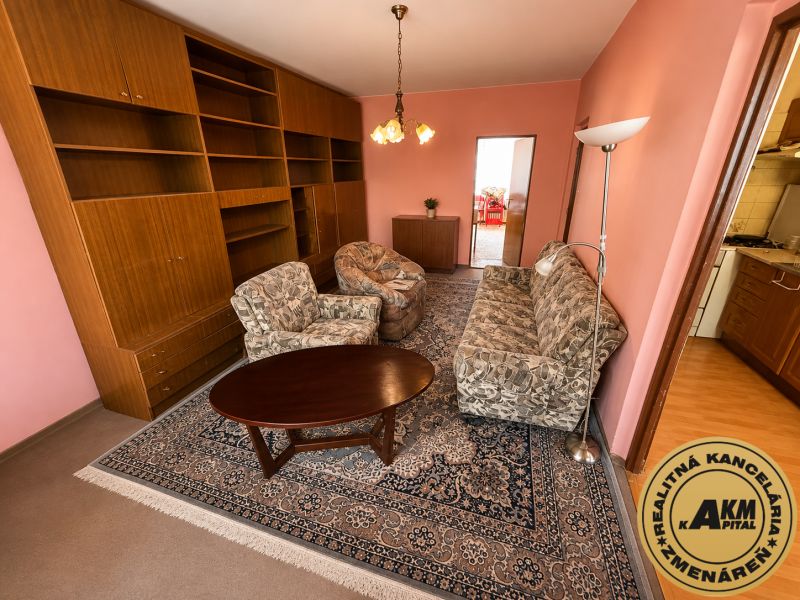 Living room in a 3-room apartment with a sofa, armchairs, and a table on a carpet.