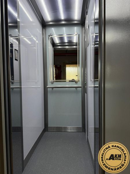 Interior of an elevator with lighting and a mirror, suitable for a 3-room apartment.