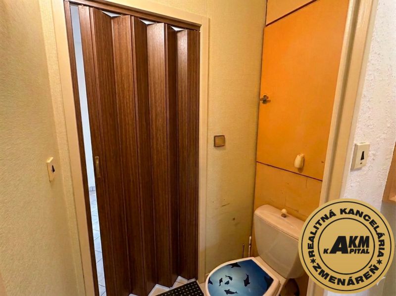 A toilet with folding doors in a 3-room apartment.