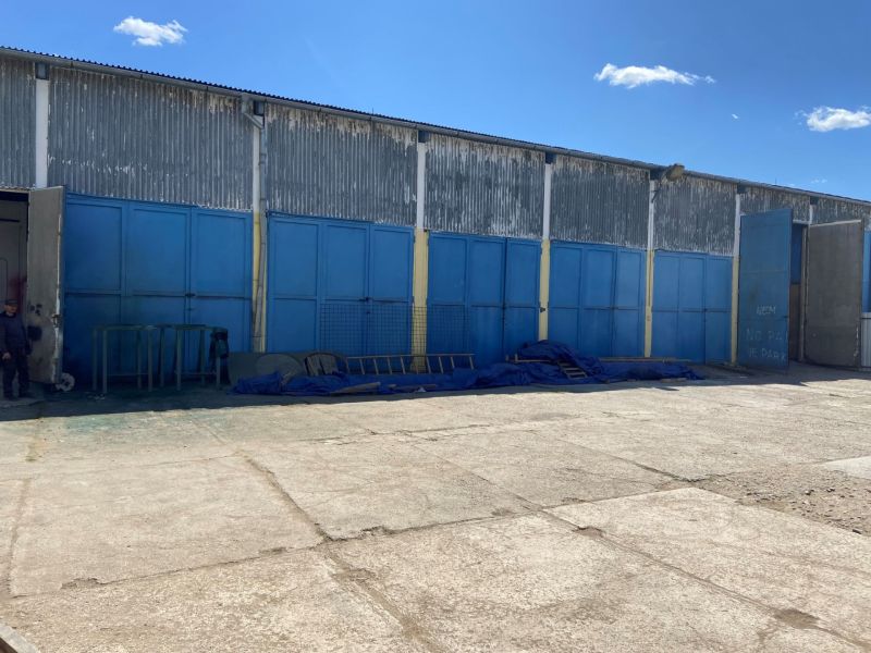 An industrial building with closed blue gates on Košická Street in Rimavská Sobota.