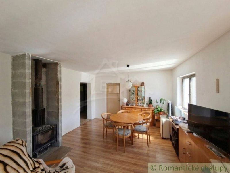 Living room in a family house with a fireplace and a wooden decor floor.